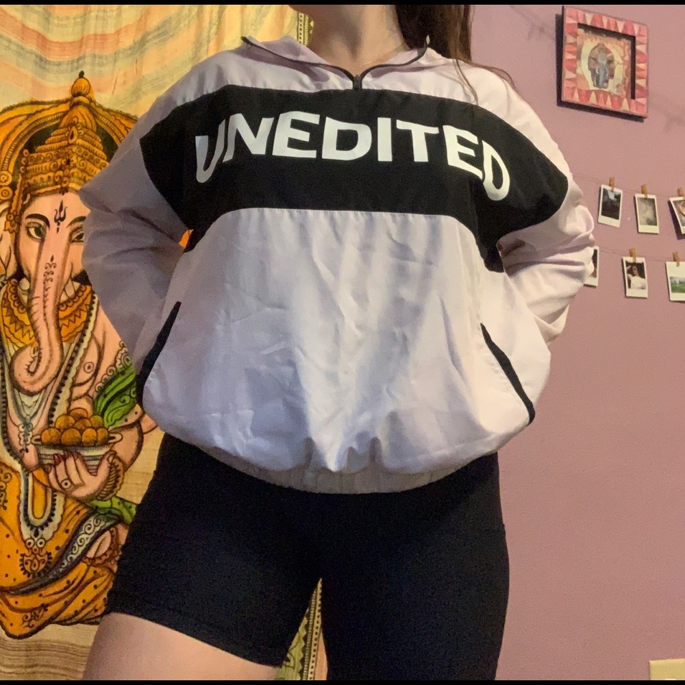 Light pink windbreaker that says “ unedited”